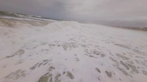 Waves roll with force on beach Stock Footage 345050643