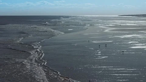 Waves roll gently onto wet sand Stock Footage 346261282