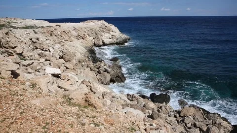Waves roll with noise onto a rocky shore and beat against the shore. Beautiful Stock Footage 122096140