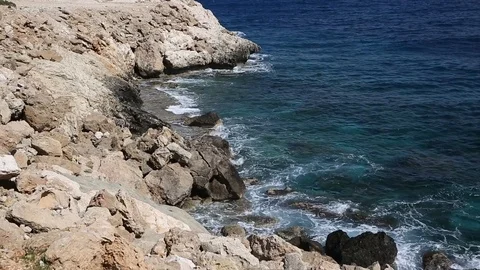 Waves roll with noise onto a rocky shore and beat against the shore. Beautiful Stock Footage 122096192