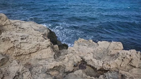 Waves roll with noise onto a rocky shore and beat against the shore. Beautiful Stock Footage 122096235