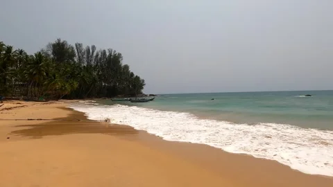 Waves roll over a beautiful sandy beach. Stock Footage 242166989