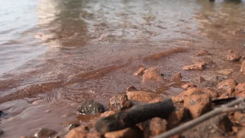 Waves roll over the rocks and slowly go back to the sea. Waves on the Sea Shore Stock Footage 146536551