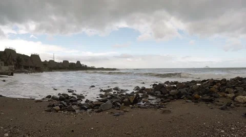 Waves Roll over a Rocky Beach in Vietnam Stock Footage 64953430