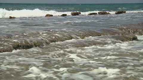 Waves roll over soft shells medium Stock Footage 32865078