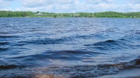 Waves roll on the river bank Stock Footage 246881329