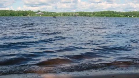 Waves roll on the river bank Stock Footage 246881330