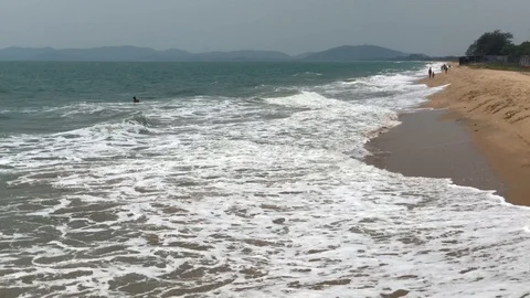 Waves roll onto a sandy beach Stock Footage 127875595