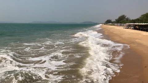 Waves roll onto a sandy beach Stock Footage 127875629