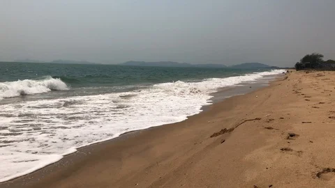 Waves roll onto a sandy beach Stock Footage 127875691