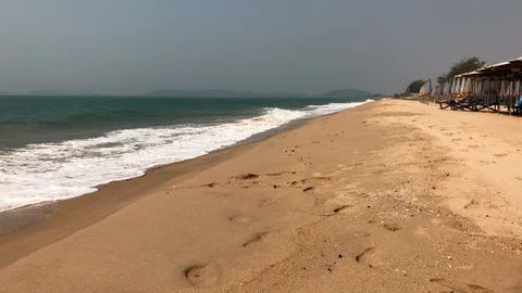 Waves roll onto a sandy beach Stock Footage 127875816
