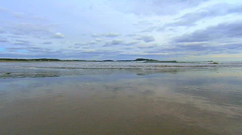 Waves roll in on sandy beach, gorgeous sky Stock Footage 538975