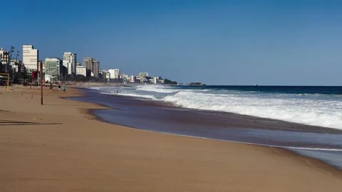 Waves roll onto a sandy beach. Rio de Janeiro, Brazil - August 28, 2024 Stock Footage 303483851