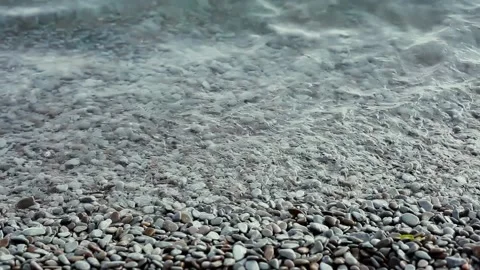 Waves roll on the sea pebble beach. The Turkish coast. A pebble sea beach Stock Footage 162224230