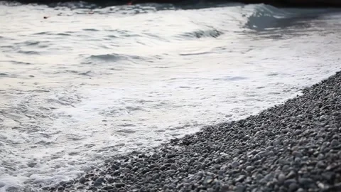 Waves roll on the seashore. The pebble beach is washed by sea waves. Stock Footage 165201378
