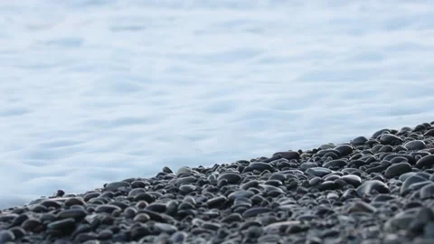 Waves roll onto the shore and move the pebbles. Coastal surf. Selective focus Stock Footage 164046223