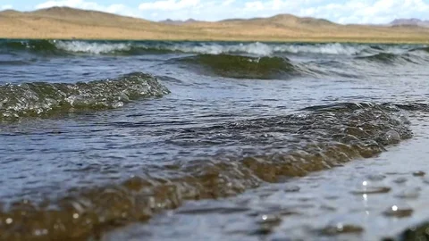 The waves roll to the shore. Stock Footage 79130692