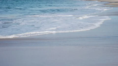 Waves roll slowly on the sandy beach. Stock Footage 276612783