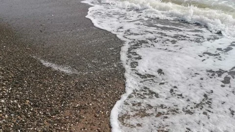 Waves roll slowly on the shore Stock Footage 133648037