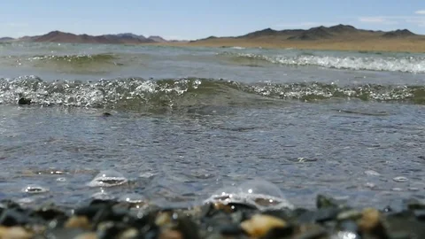 The waves rolled on a pebbly beach. Stock Footage 79130671