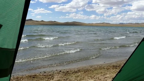 The waves rolled slowly on a beach. View from the tourist tent. Stock Footage 79776306