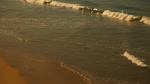 Waves Rolling Along a Beach at Sunset - HD Video 스톡 동영상 90182322