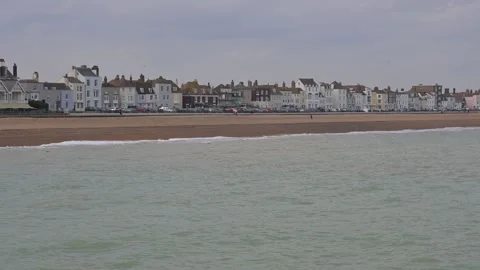 Waves rolling onto the beach in Deal, Kent with buildings in the background Stock Footage 268021916