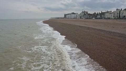 Waves rolling onto the beach in Deal, Kent with buildings in the background Stock Footage 268022438