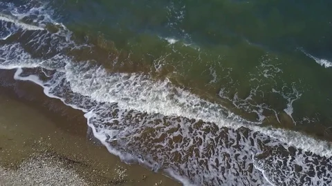 Waves rolling into beach slowly Stock Footage 82868999