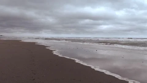 Waves rolling on beach on a stormy day Stock Footage 332898235