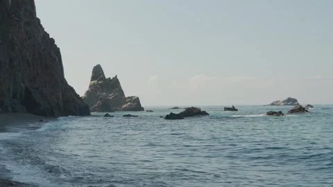 Waves Rolling beside a Cliff and Sea Stack in Asturias Stock Footage 347916116