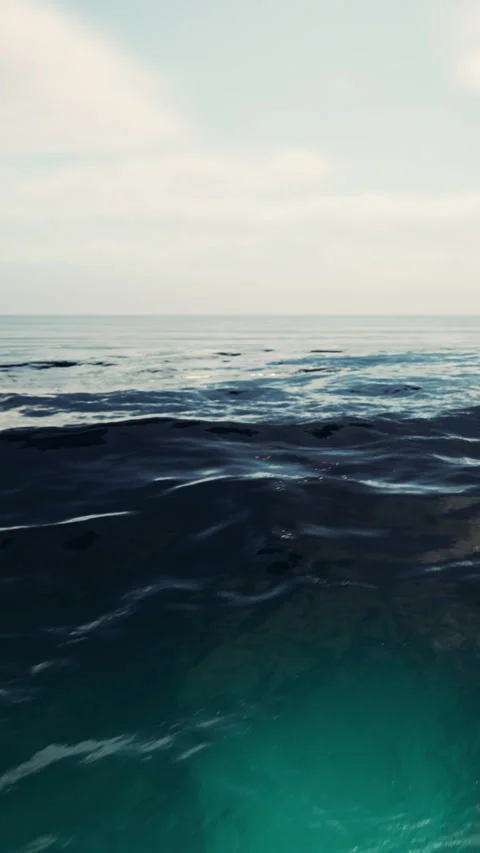 Waves rolling on a calm ocean under a blue sky in midday light Stock Footage 342166186