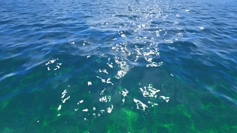 Waves rolling on the calm, shimmering sea Stock Footage 322915088