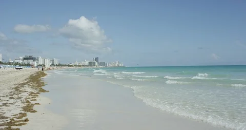 Waves rolling in at low tide in South Beach Miami Stock Footage 107634291