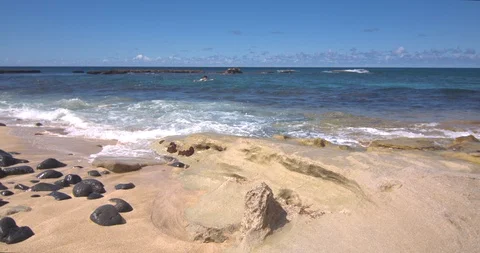 Waves Rolling in Near Three Tables on Oahu as a Surfer Paddles Out Stock Footage 104377040