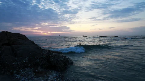 Waves rolling over rocks at sunrise tracking Stock Footage 29943943