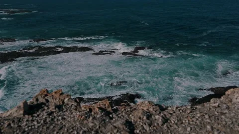 Waves rolling over rocky reefs seen from the cliff edge, Cabo Sardao, Portugal Stock Footage 346479875