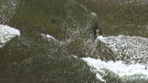 Waves rolling in over rocky shoteline, aeroal top down view Stock Footage 153275604