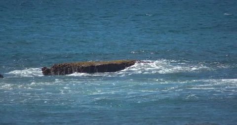 Waves Rolling over Three Tables on the North Shore of Oahu Stock Footage 104373192