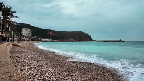 Waves rolling onto pebble beach, Javea, Costa Blanca, Spain Stock Footage 342317909