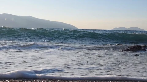Waves rolling on a pebble sand beach Video stock 120764035