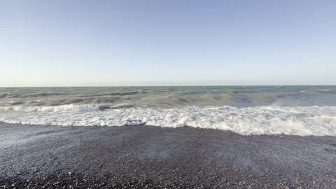Waves Rolling onto Pebble Shore in Soft Morning Light, 4K Stock Footage 338325393