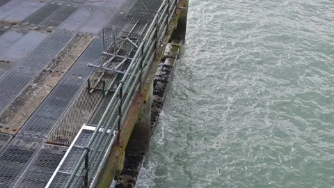 Waves rolling onto pier supports in Deal, Kent Stock Footage 268021199
