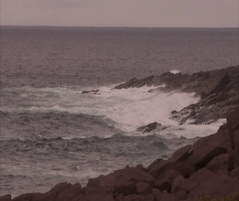 Waves rolling in on rocky coast Stock Footage 86698229