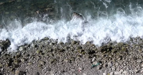 Waves Rolling in on a Rocky Sea Beach Aerial View Stock Footage 68916404