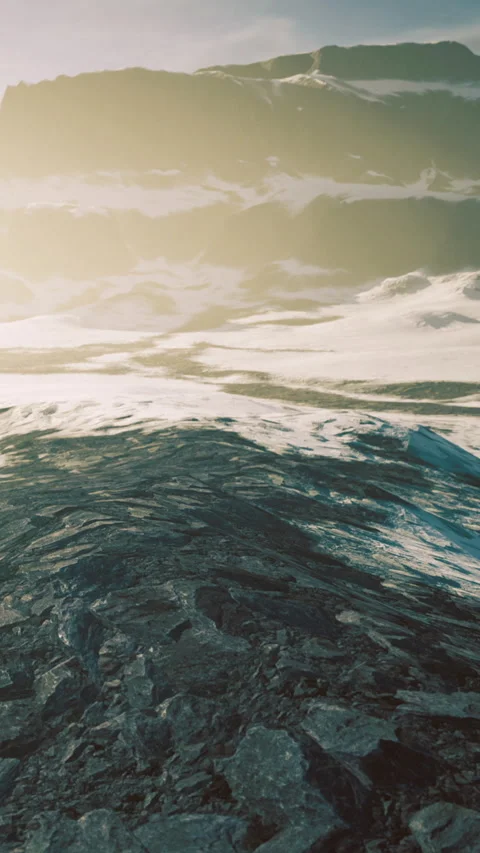 Waves rolling on rocky shore during sunset near mountain landscape Stock Footage 334186392