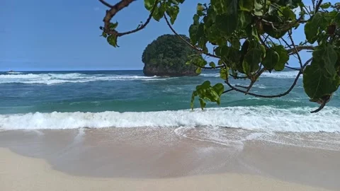 Waves rolling up sandy beach in Malang Indonesia Stock Footage 152671213