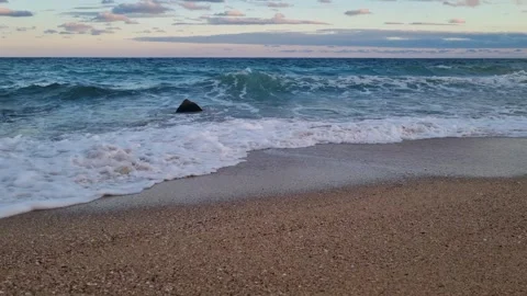 Waves Rolling on the Sandy Beach at Sunset Stock Footage 319817721