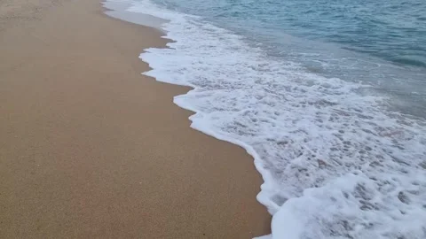 Waves rolling onto sandy coastline creating relaxing natural seaside motion Video stock 321651119