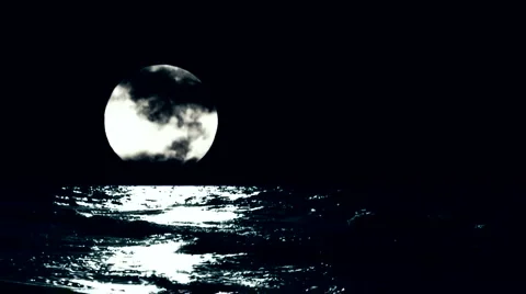 Waves rolling in set against timelapse full moon Stock Footage 1036128